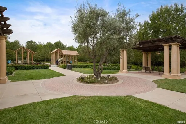 a view of a green field with trees in the background
