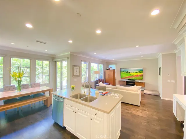 a large white kitchen with a large window
