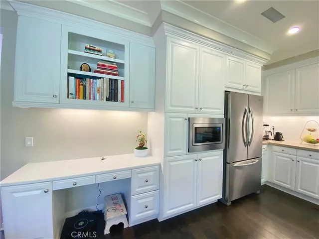 a kitchen with stainless steel appliances a refrigerator sink and cabinets