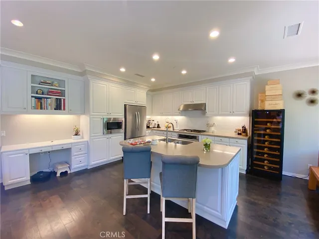 a large kitchen with a table and chairs in it