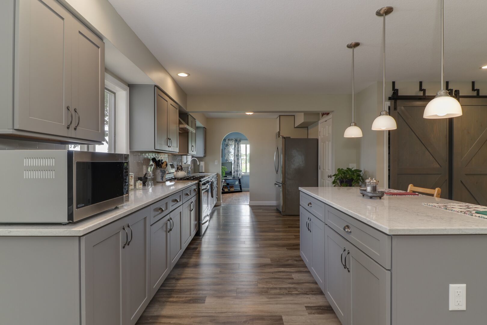 509 Division Road Wapella, IL 61777 - Photo 5 of 27 a large kitchen with kitchen island a sink stainless steel appliances and cabinets
