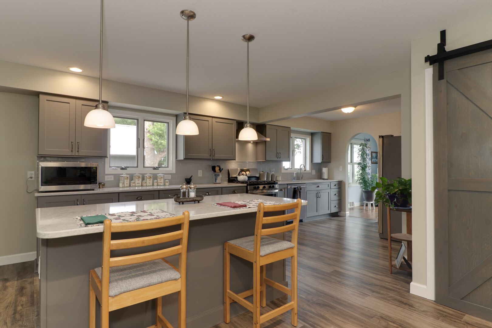 509 Division Road Wapella, IL 61777 - Photo 6 of 27 a kitchen with a table chairs microwave and cabinets