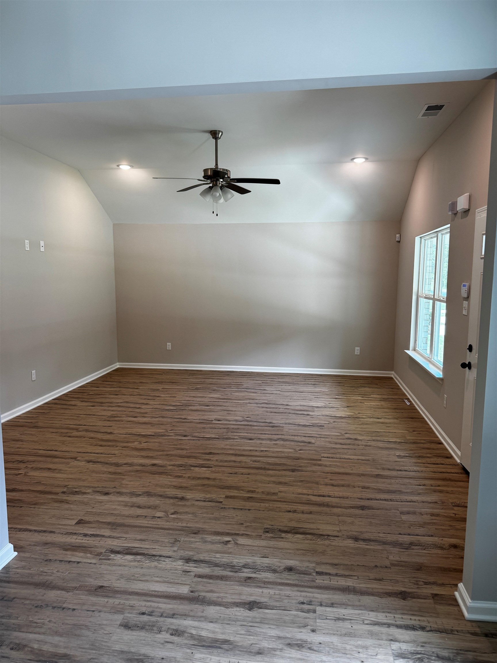 5283 Zodiac Road Memphis, TN 38118 - Photo 3 of 13 Expansive room featuring wood-finish flooring, vaulted ceilings, and recessed lighting