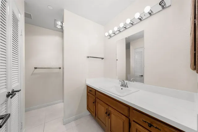 a bathroom with a double vanity sink and a mirror