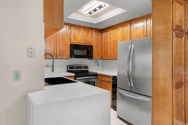 a kitchen with stainless steel appliances a refrigerator stove microwave and sink