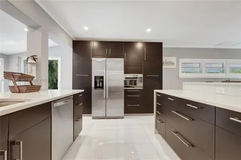 a kitchen with a refrigerator and a sink
