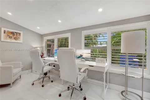 a living room with furniture a ceiling fan and a window