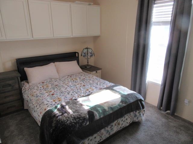 3251 E Road, Unit 99 Clifton, CO 81520 - Photo 21 of 25 a bed sitting in a bedroom next to a window