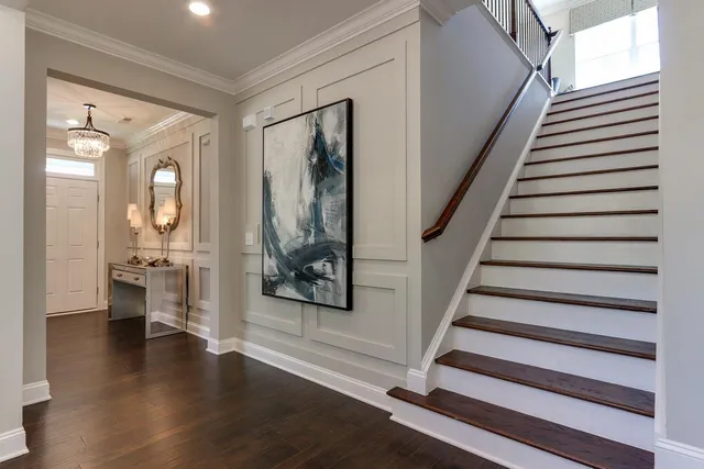 a view of a hallway with wooden floor and windows