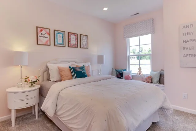 a bedroom with a bed and a painting on the wall