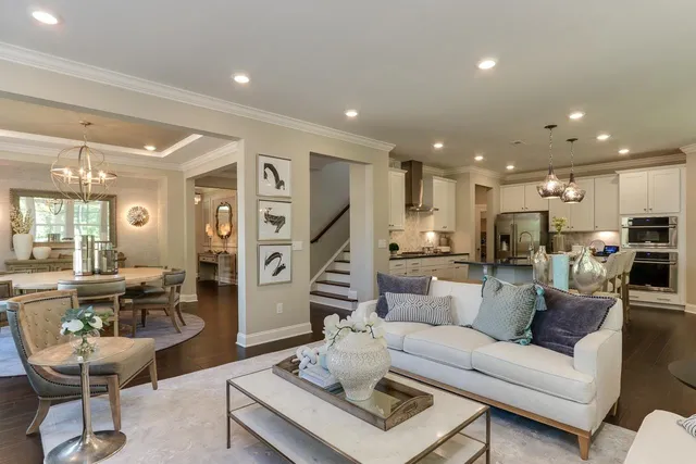 a living room with furniture kitchen view and a table