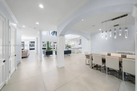 a living room with fireplace furniture and floor to ceiling window