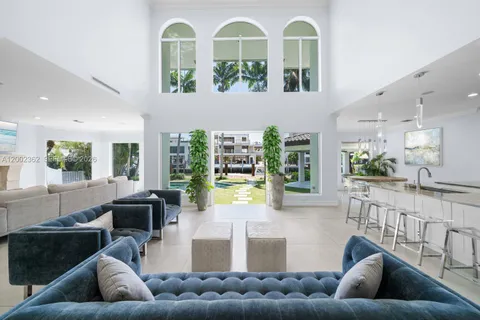 a large kitchen with stainless steel appliances granite countertop a sink and cabinets