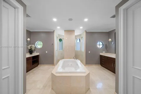 a spacious bedroom with a bed and a large mirror