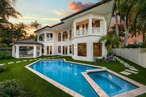 a view of a house with swimming pool and a yard