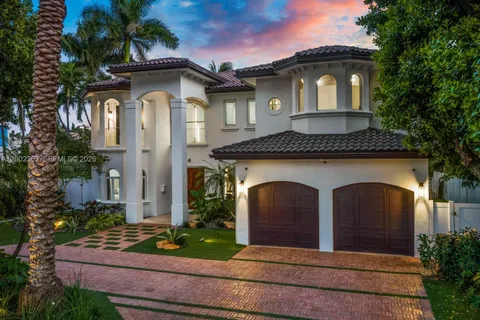 a white building with a clock on the front door