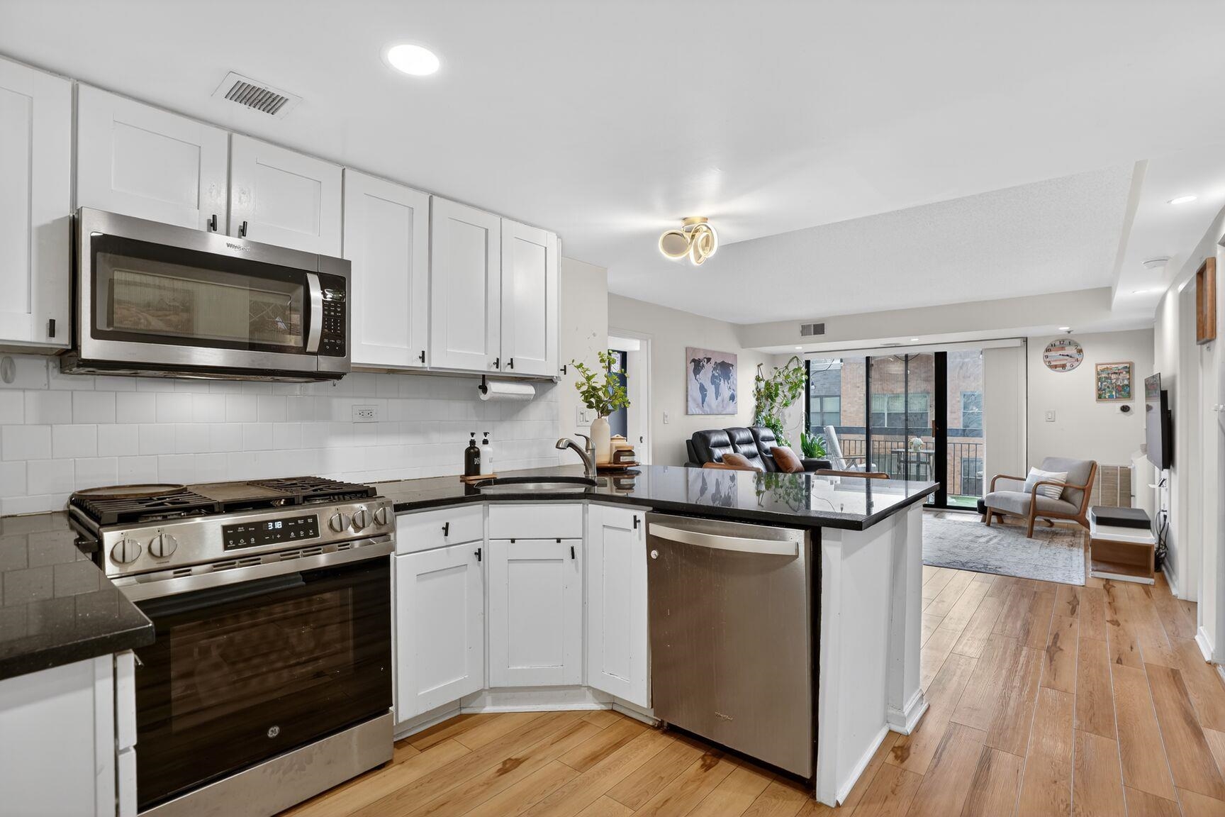 700 1st Street, Unit 7T Hoboken, NJ 07030 - Photo 4 of 25 a kitchen with a sink stove and microwave