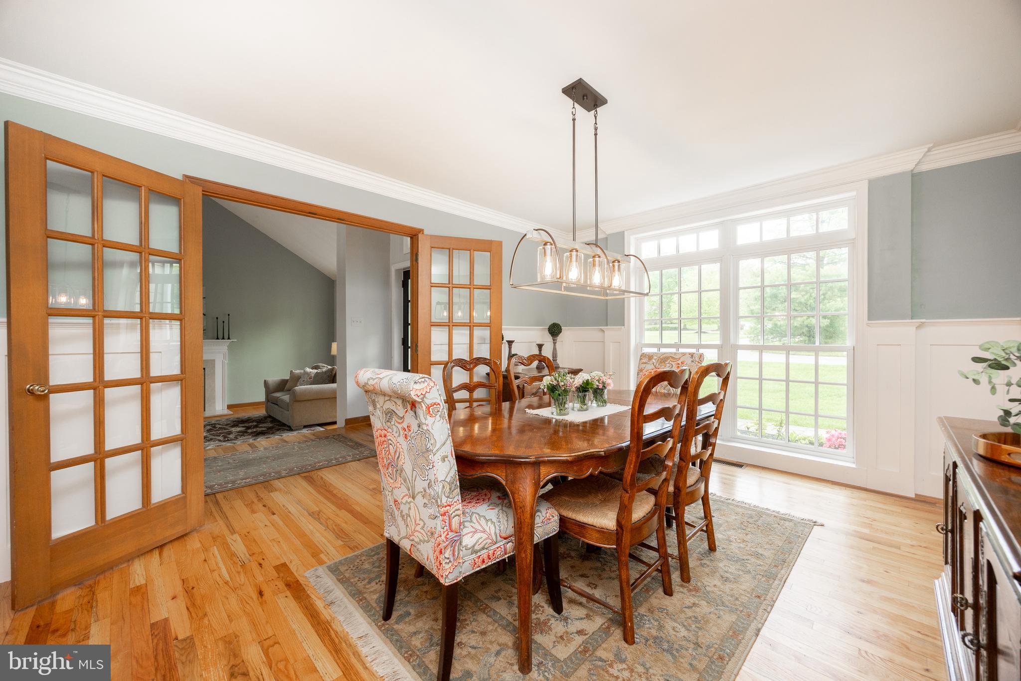 10 Brampton Road Malvern, PA 19355 - Photo 11 of 49 a view of a dining room and livingroom with furniture wooden floor a chandelier
