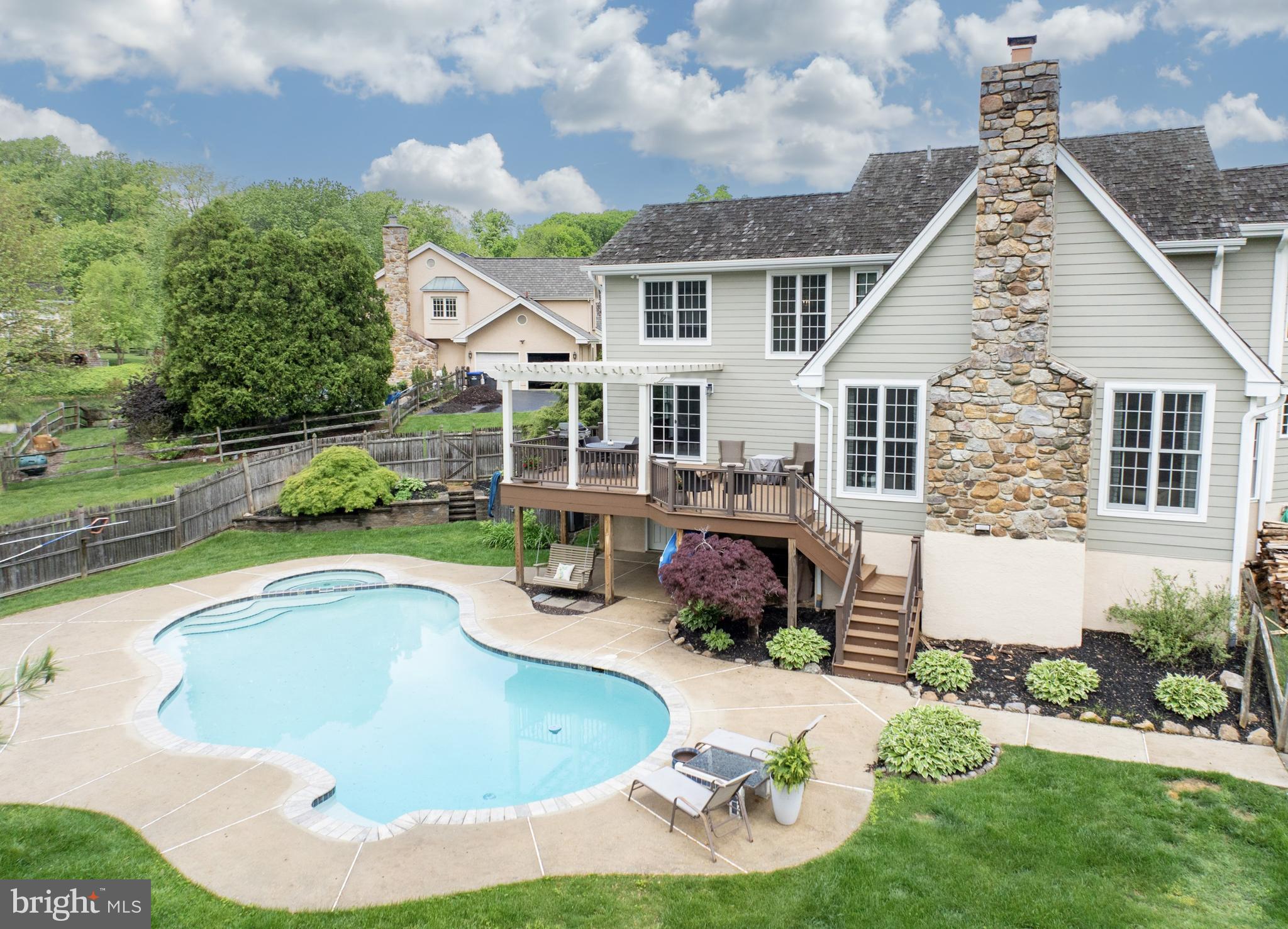 10 Brampton Road Malvern, PA 19355 - Photo 16 of 49 a swimming pool with outdoor seating and yard