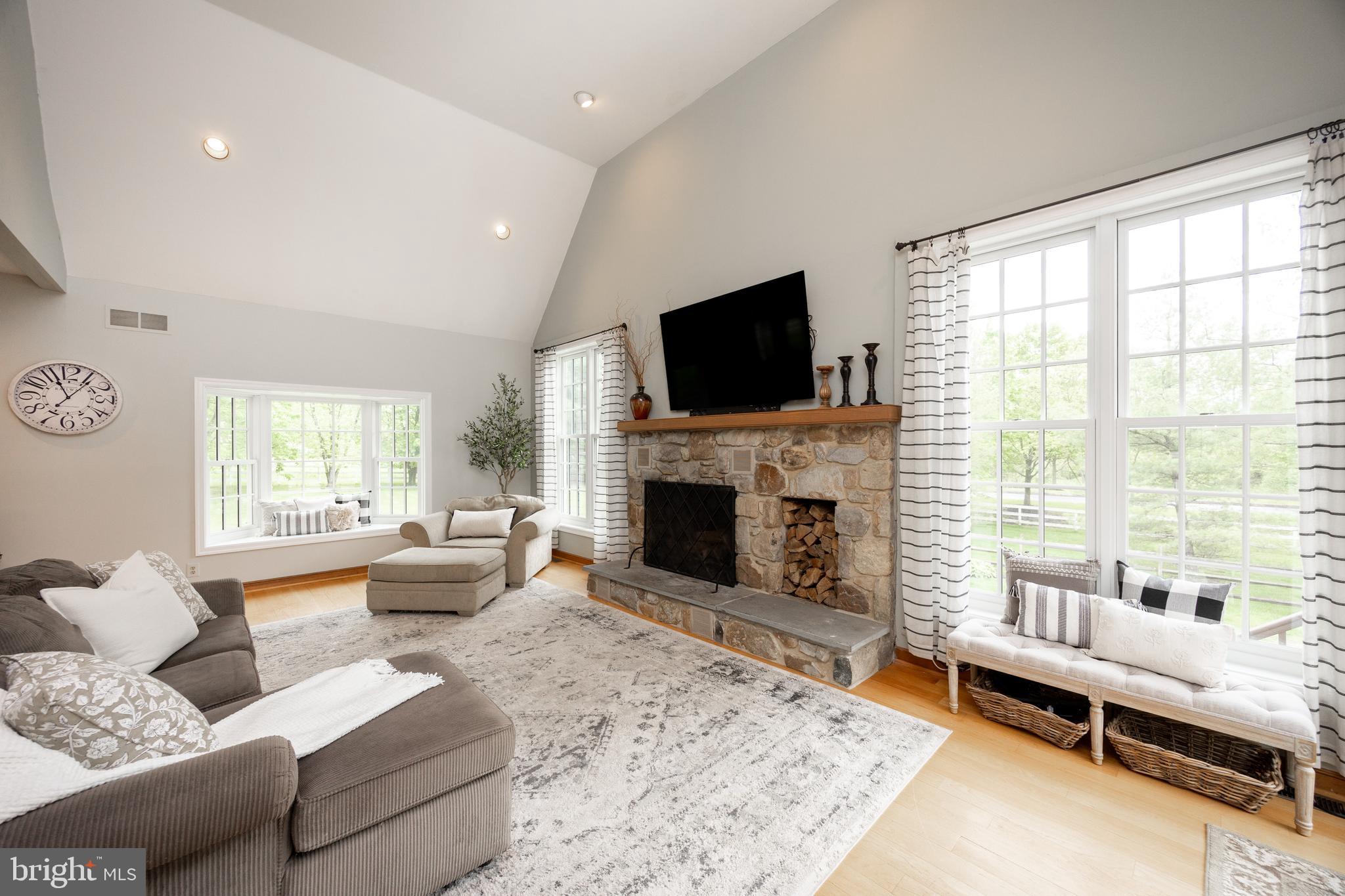 10 Brampton Road Malvern, PA 19355 - Photo 19 of 49 a living room with furniture fireplace and a flat screen tv
