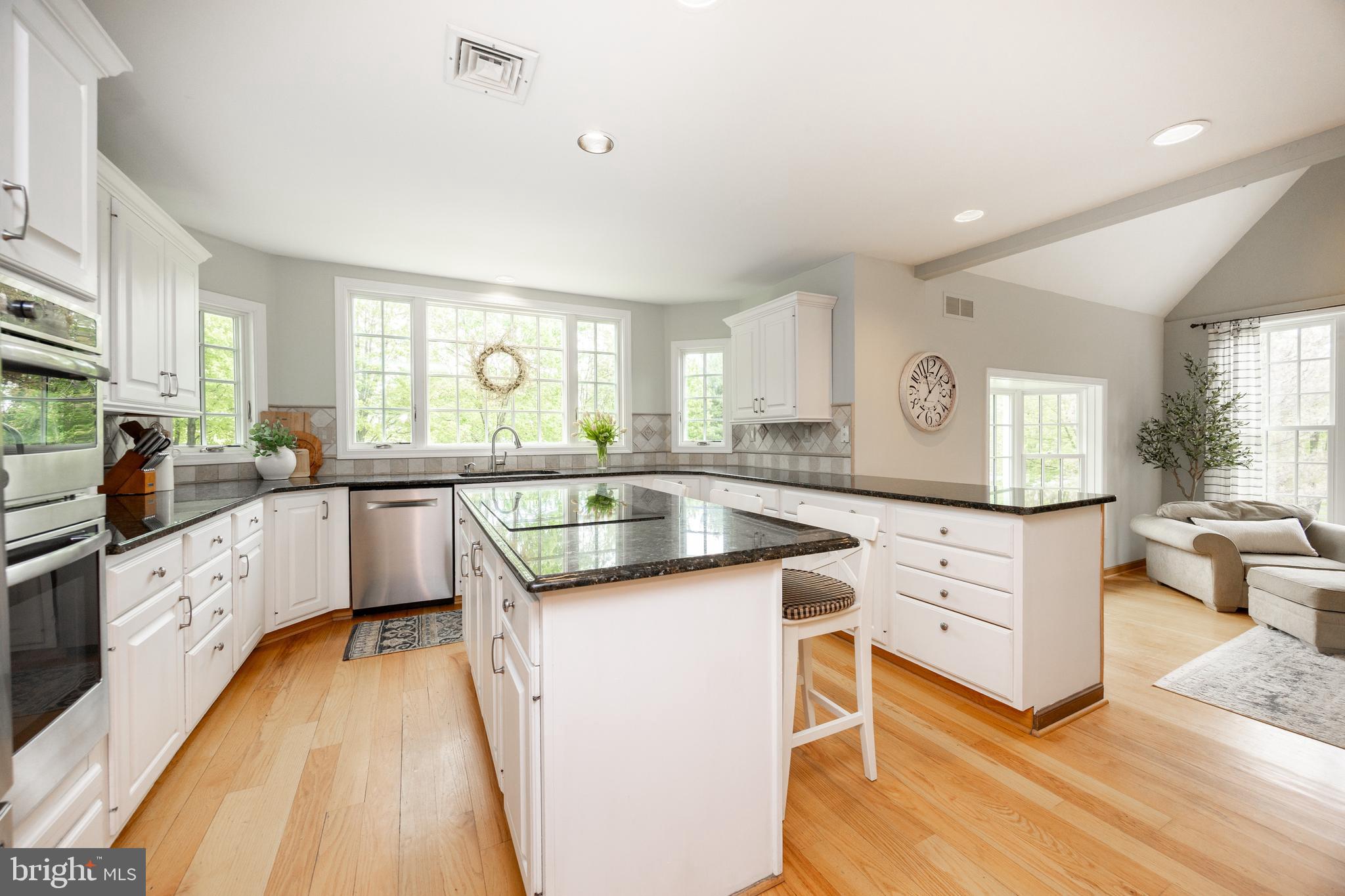 10 Brampton Road Malvern, PA 19355 - Photo 21 of 49 a kitchen with granite countertop a sink cabinets wooden floor and stainless steel appliances
