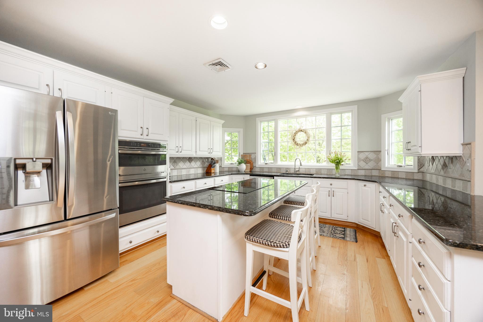 10 Brampton Road Malvern, PA 19355 - Photo 23 of 49 a kitchen with a refrigerator a sink and white cabinets