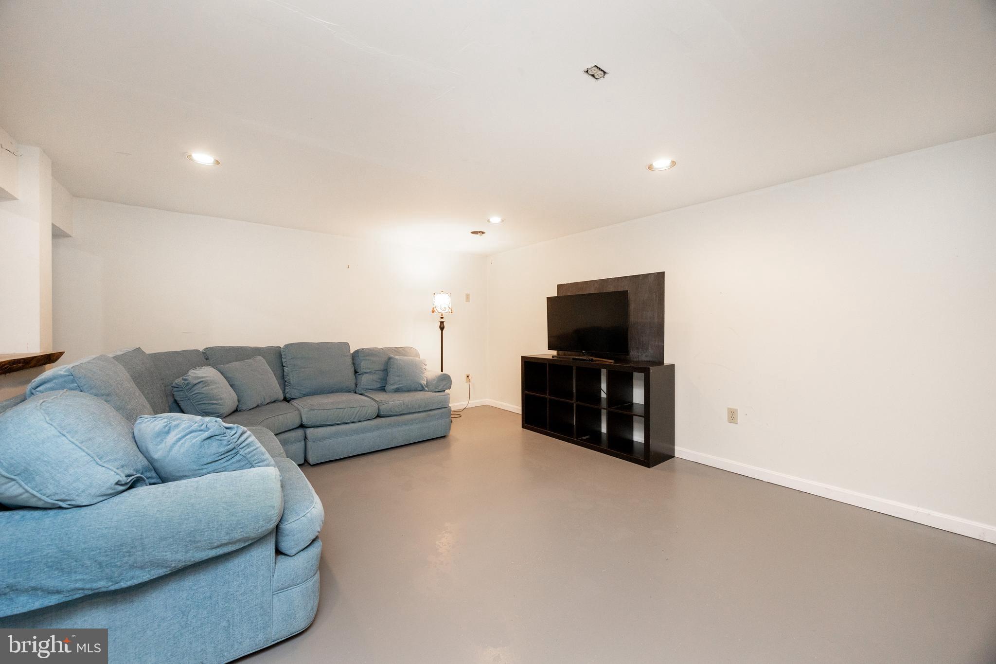 10 Brampton Road Malvern, PA 19355 - Photo 38 of 49 a living room with furniture and a flat screen tv