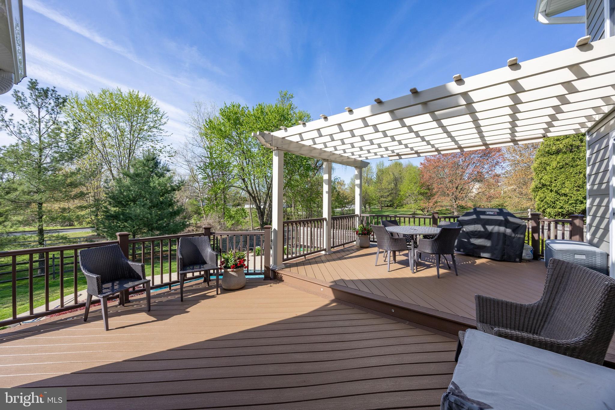10 Brampton Road Malvern, PA 19355 - Photo 5 of 49 a view of a patio with couches chairs dining table and chairs with wooden floor