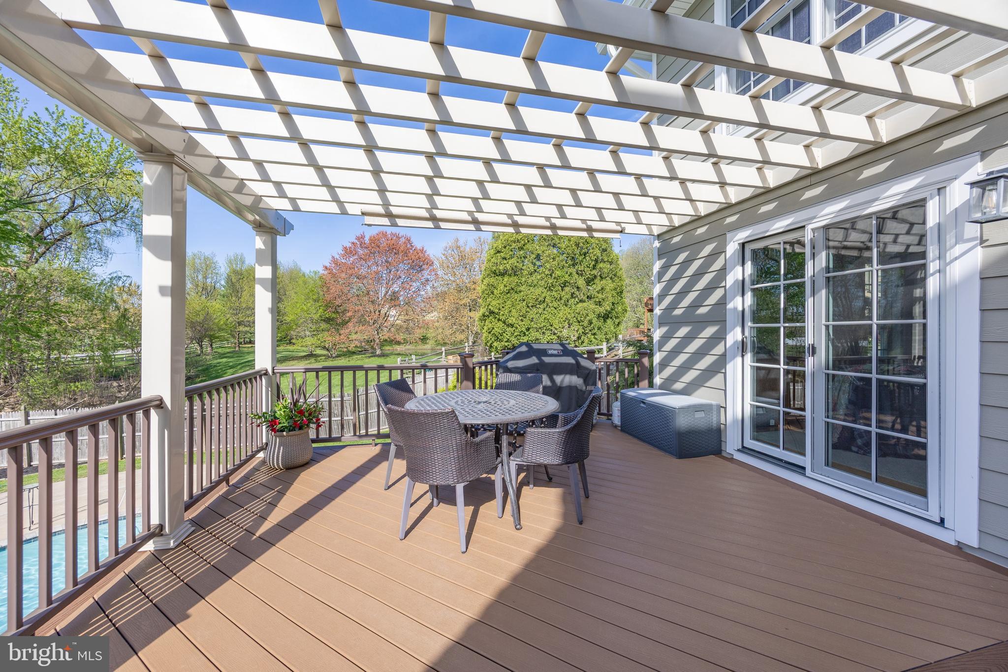 10 Brampton Road Malvern, PA 19355 - Photo 6 of 49 a roof deck with table and chairs and wooden floor