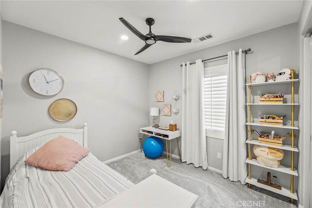 19663 Griffith Drive Saugus, CA 91350 - Photo 11 of 28 a bedroom with a bed and a chandelier