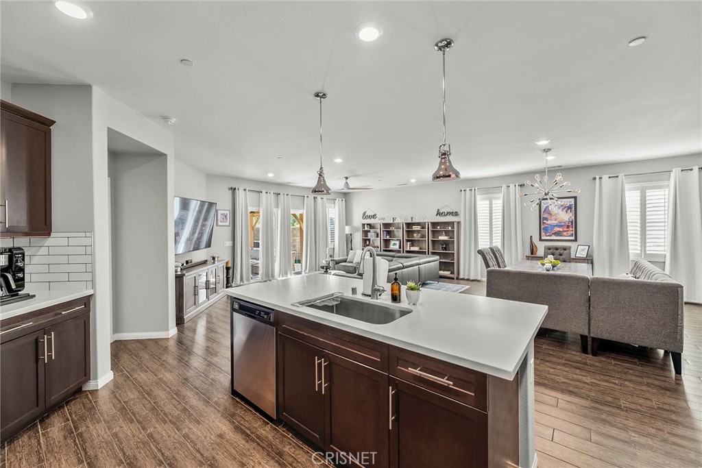 19663 Griffith Drive Saugus, CA 91350 - Photo 7 of 28 a kitchen with kitchen island a sink appliances and wooden floor