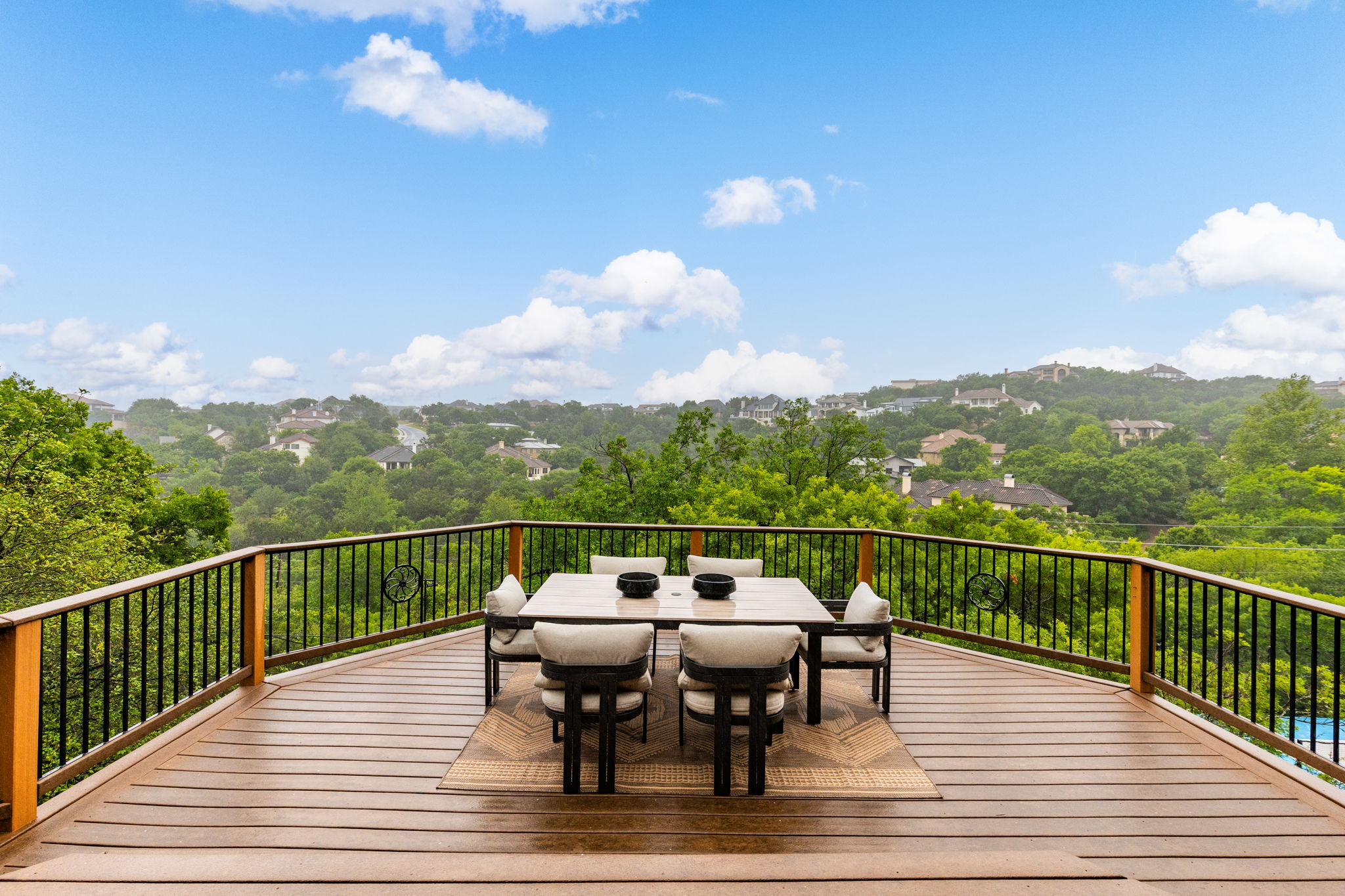 2807 Round Table Road Austin, TX 78746 - Photo 11 of 40 Expansive outdoor deck featuring wood-finish flooring and a black metal railing with wood posts
