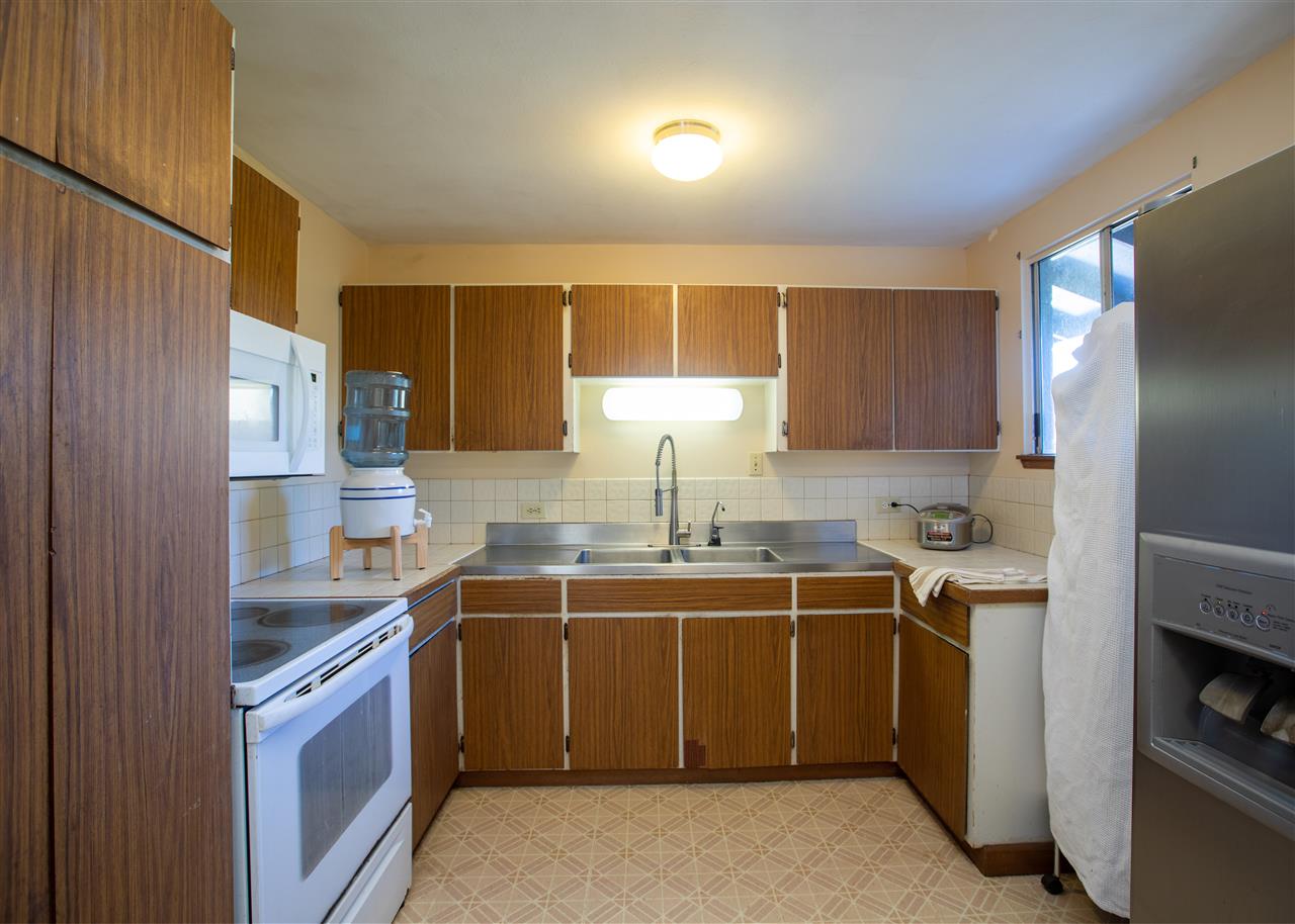 586 Naalae Road Kula, HI 96790 - Photo 13 of 30 a kitchen with a sink stove and cabinets