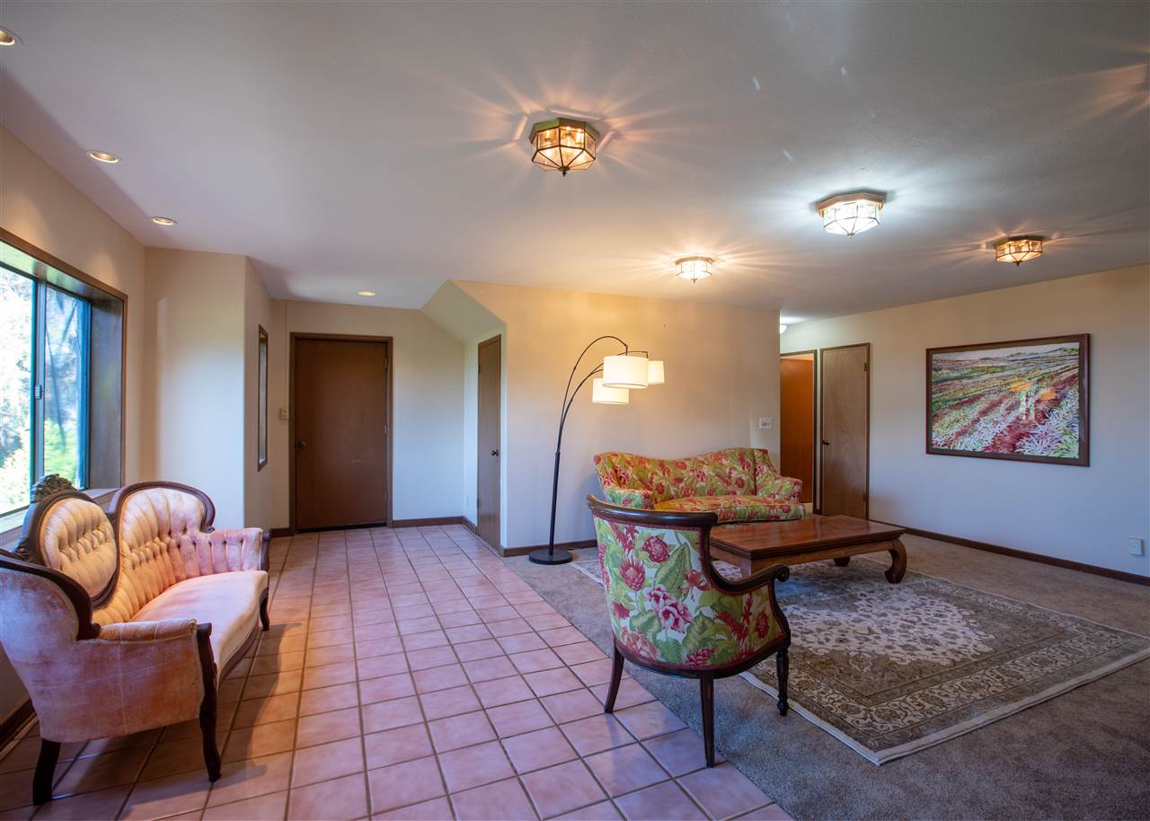 586 Naalae Road Kula, HI 96790 - Photo 10 of 30 a living room with furniture and wooden floor