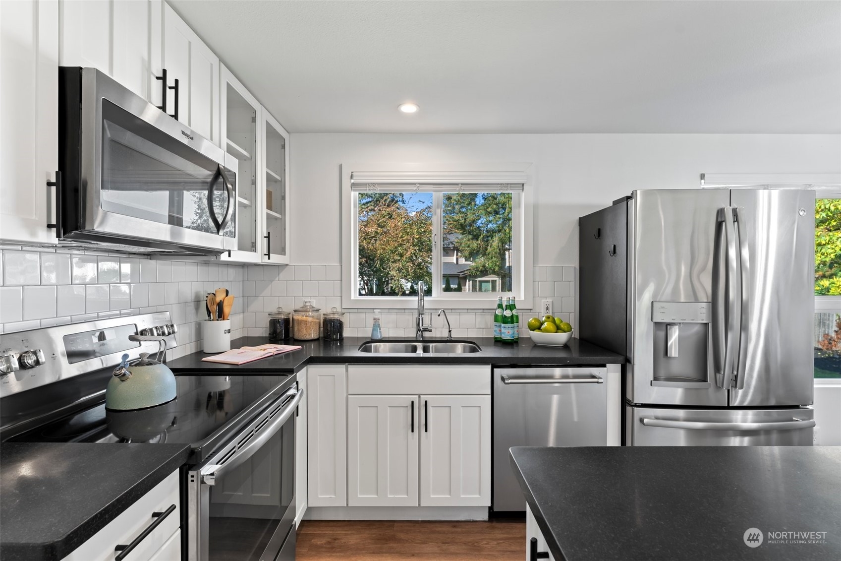 207 Elma Place Southeast Renton, WA 98059 - Photo 8 of 35 a kitchen with stainless steel appliances a sink stove and cabinets