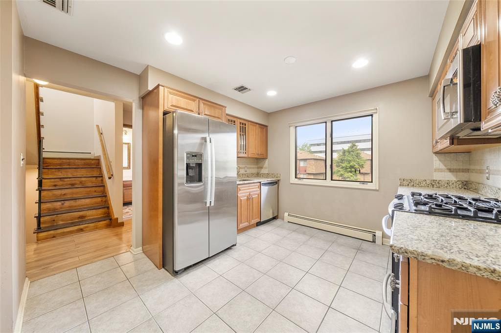 140 Allwood Road, Unit C Clifton, NJ 07012 - Photo 16 of 31 a kitchen with granite countertop a refrigerator and a stove