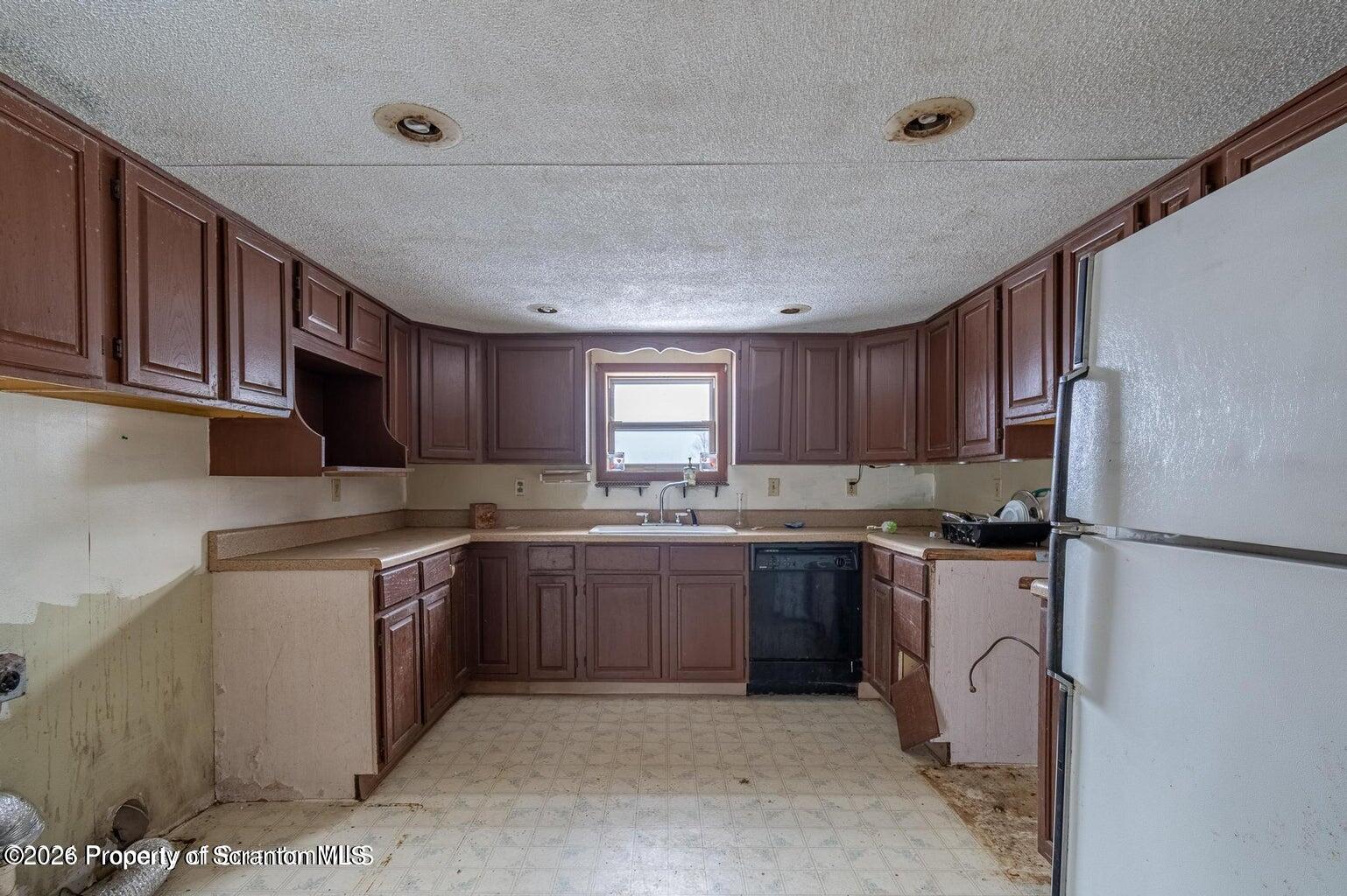 1777 Lamb Road Thompson, PA 18465 - Photo 11 of 31 a kitchen with stainless steel appliances granite countertop a stove sink and refrigerator