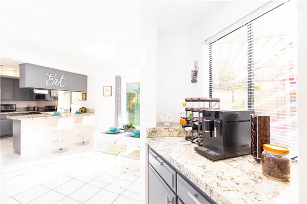 a kitchen with a stove a sink and a refrigerator