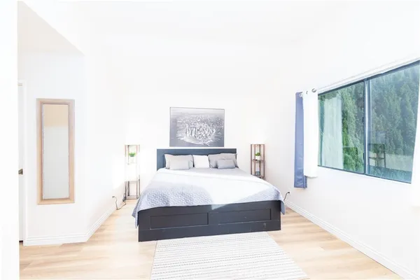 a bedroom with a large bed and a large window