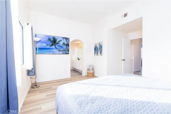 a bedroom with a bed and a painting on the wall