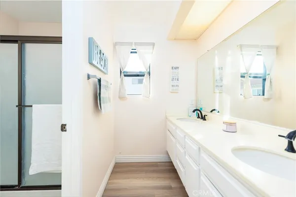 a spacious bathroom with a double vanity sink and a mirror