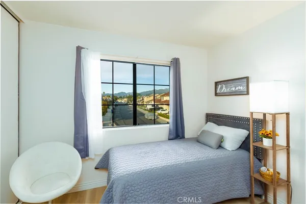 a bedroom with a bed and window