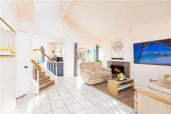 a living room with furniture and a fireplace with wooden floor