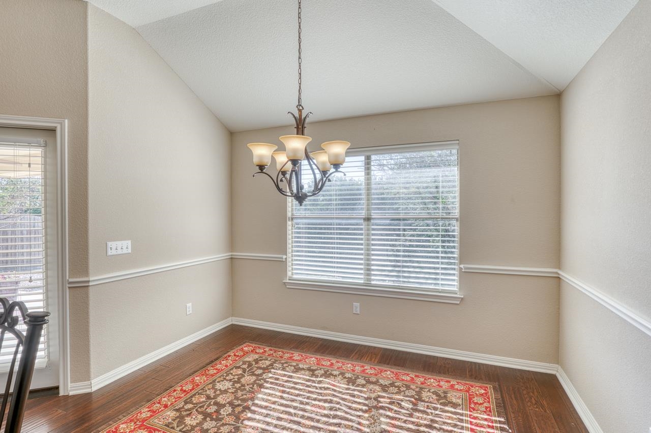 1403 Adam Burnet, TX 78611 - Photo 13 of 30 a view of a room with a large window ceiling fan and hardwood floor