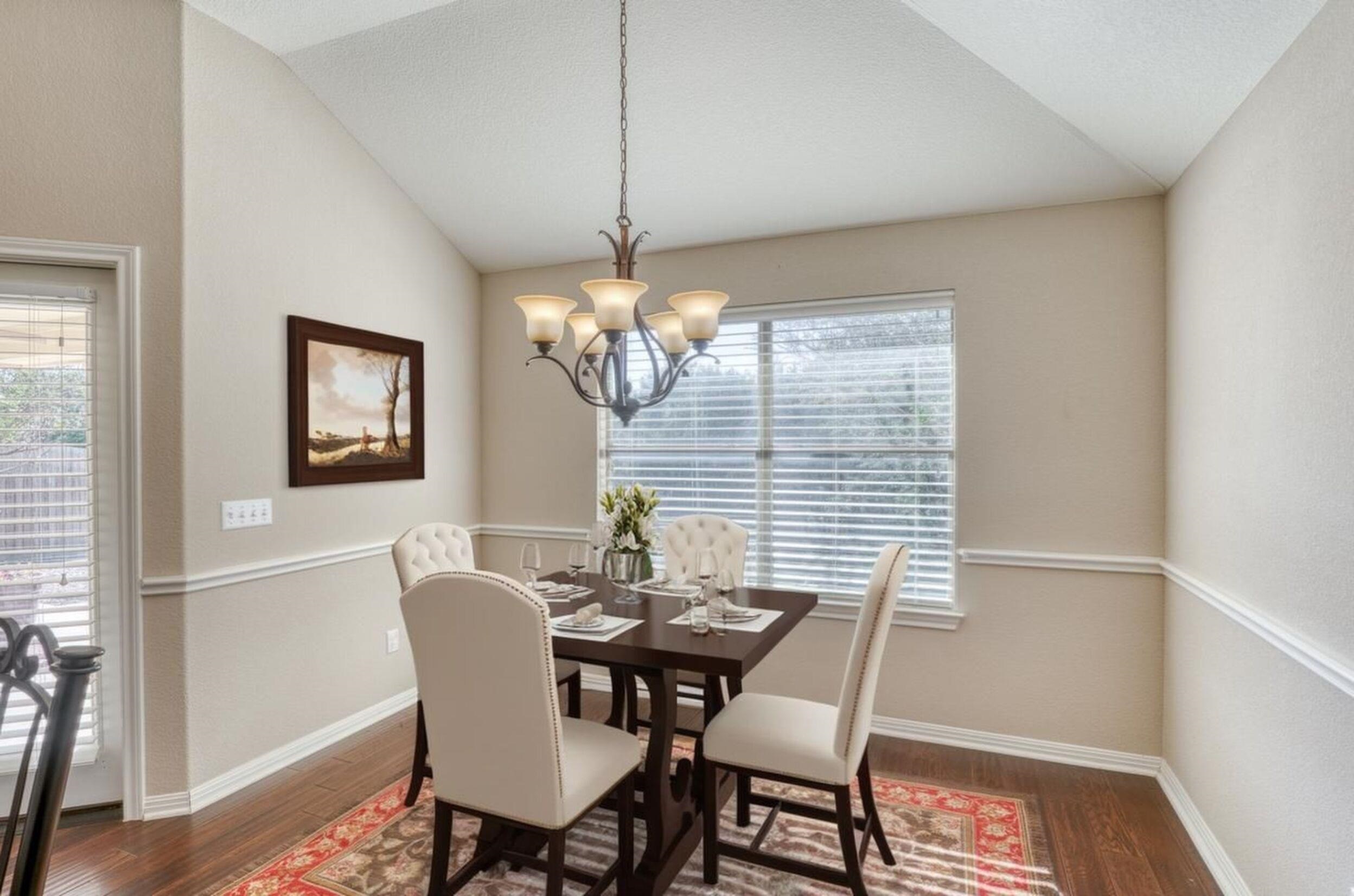 1403 Adam Burnet, TX 78611 - Photo 14 of 30 a view of a dining room with furniture wooden floor and a chandelier