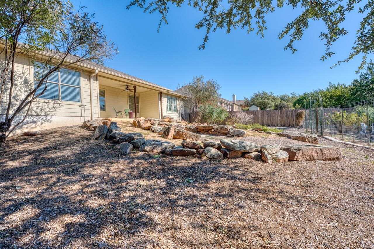 1403 Adam Burnet, TX 78611 - Photo 26 of 30 a backyard of a house with table and chairs