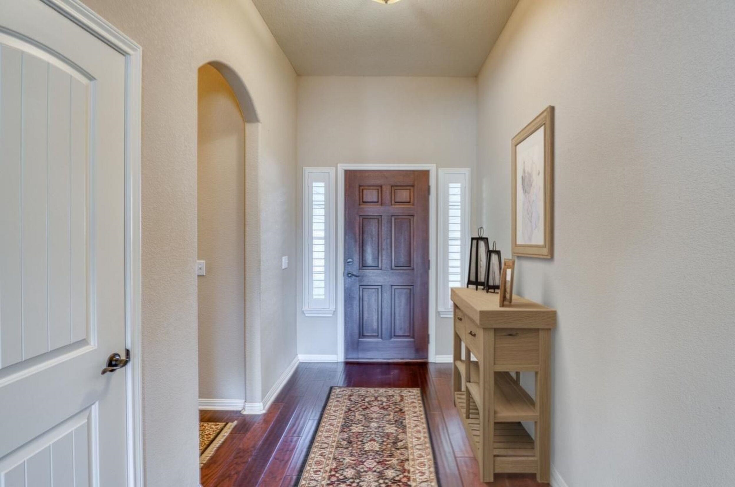 1403 Adam Burnet, TX 78611 - Photo 5 of 30 a view of hallway with mirror and a window