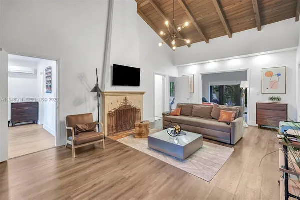 a living room with furniture a fireplace and a flat screen tv