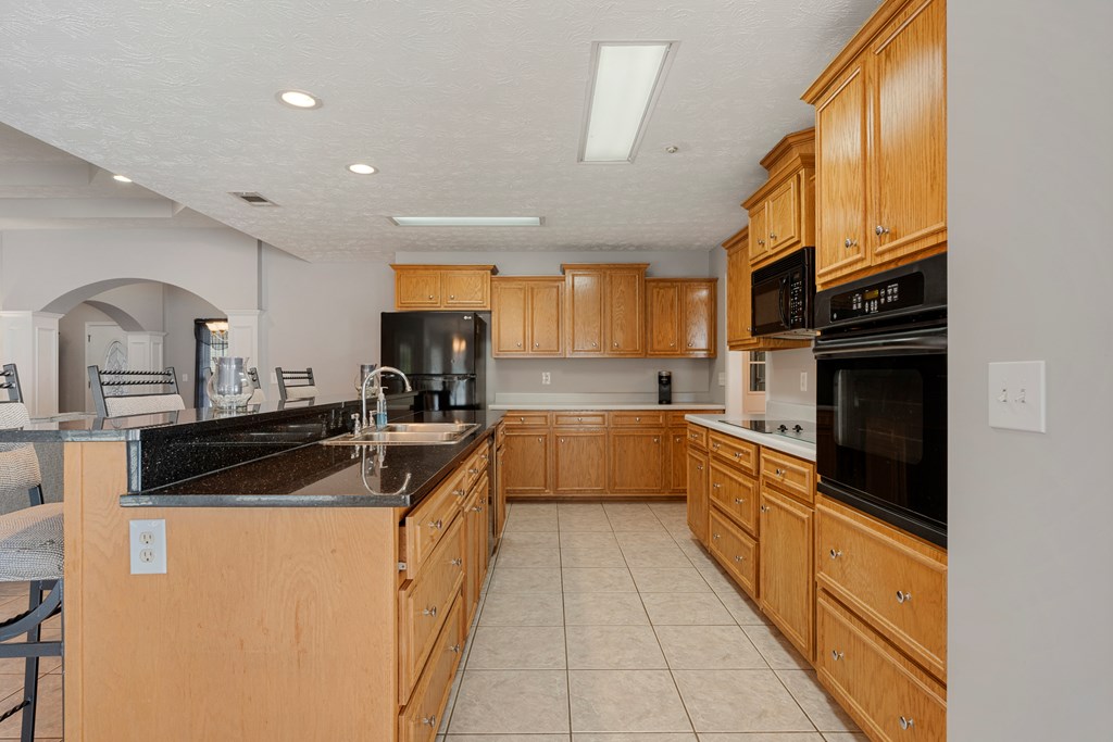 2034 Lee Road Salem, AL 36874 - Photo 14 of 47 a kitchen with stainless steel appliances granite countertop a sink and cabinets