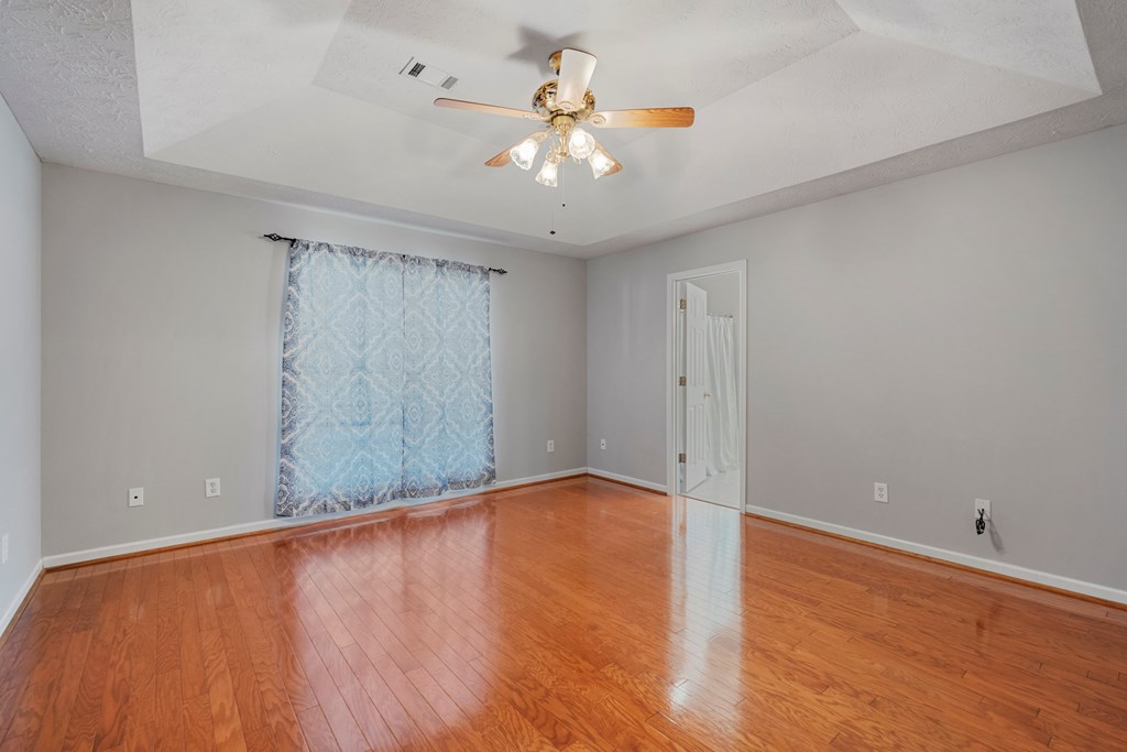 2034 Lee Road Salem, AL 36874 - Photo 17 of 47 wooden floor in an empty room with a chandelier fan